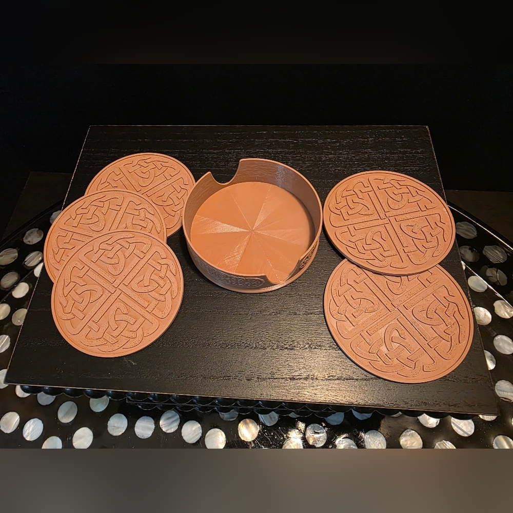 A celtic themed set of coasters with a matching holder